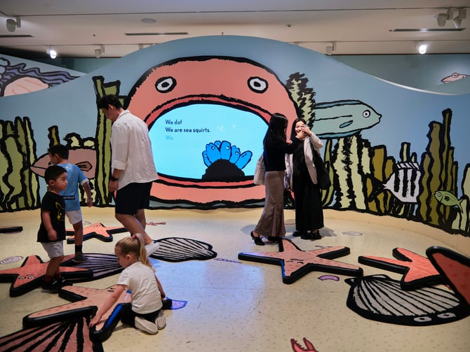 Kids playing in a colorful interactive exhibit at a children's museum